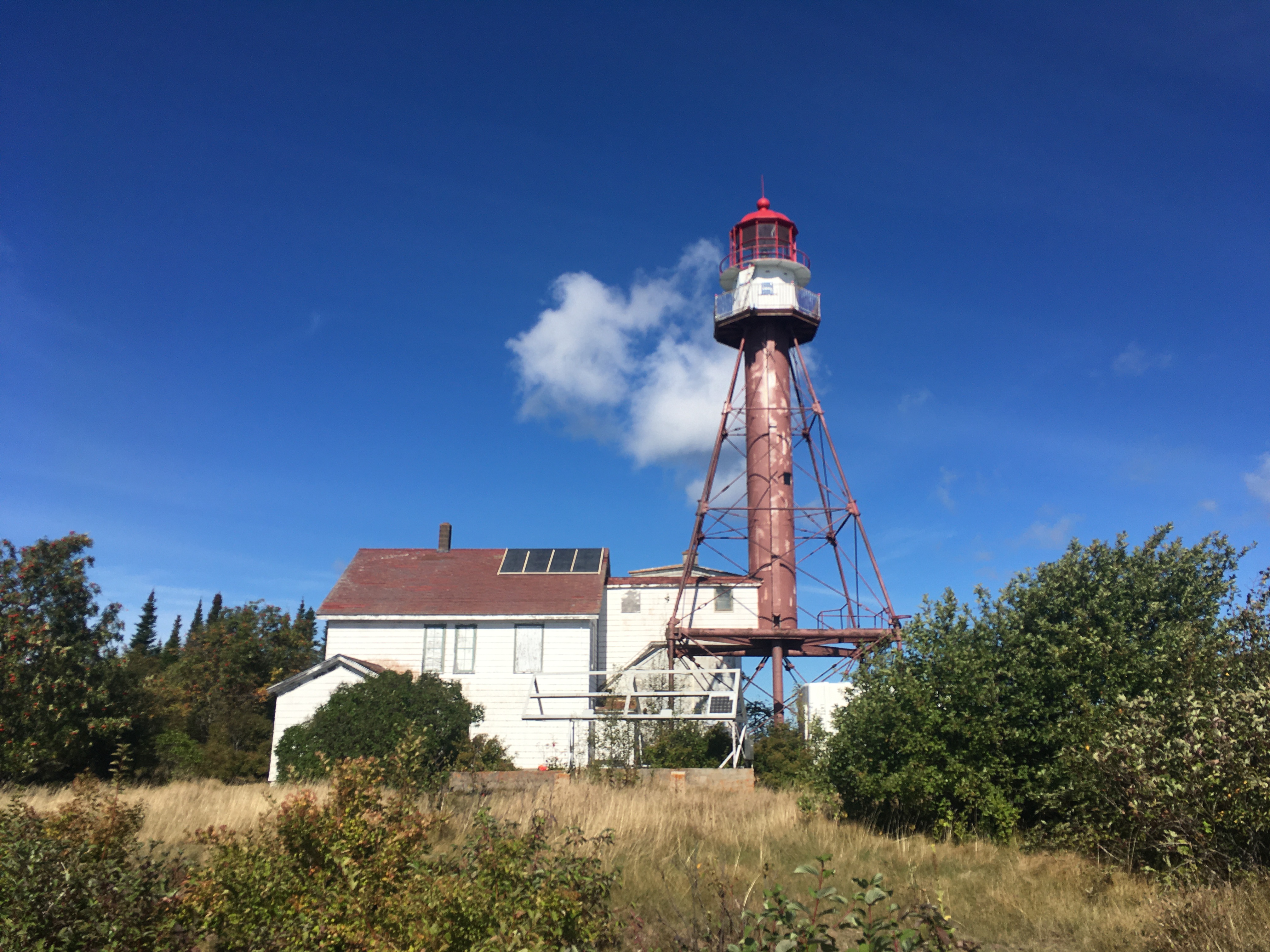 A photo of the keeper’s dwelling and light tower at the Manitou Island Light Station.